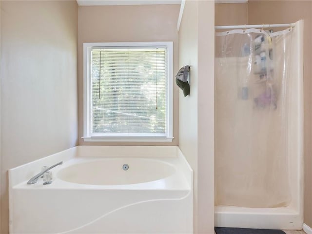 bathroom featuring a shower stall and a garden tub