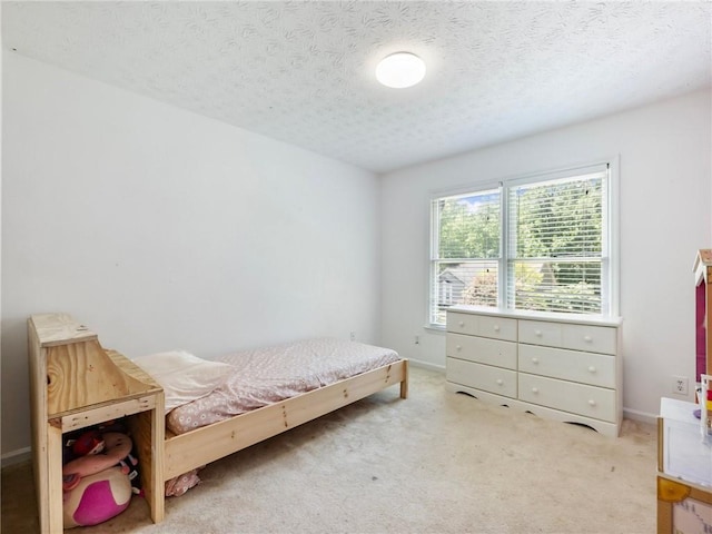 bedroom with a textured ceiling and carpet floors