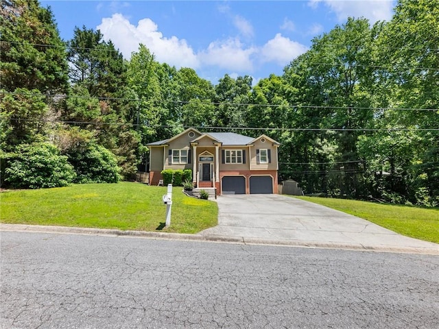 bi-level home featuring an attached garage, concrete driveway, and a front lawn