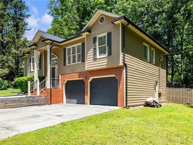 split foyer home featuring an attached garage, brick siding, and concrete driveway