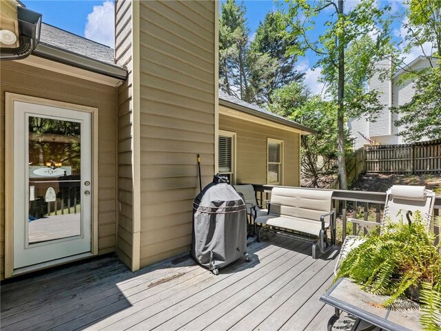 wooden terrace featuring fence