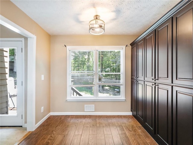 entryway featuring light wood-style floors and baseboards