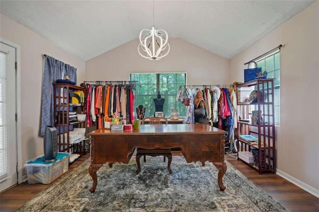 office area with dark wood-type flooring, lofted ceiling, plenty of natural light, and an inviting chandelier