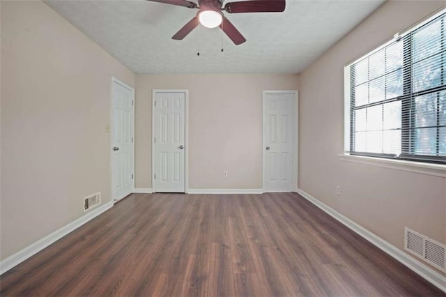 unfurnished room featuring dark hardwood / wood-style floors and ceiling fan