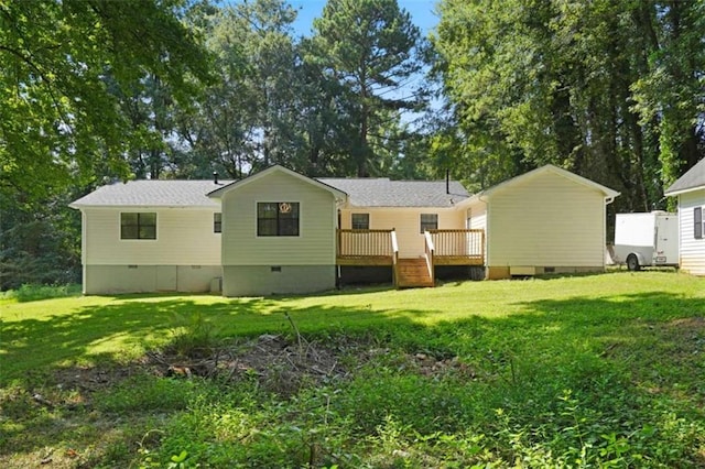 back of house featuring a yard and a deck