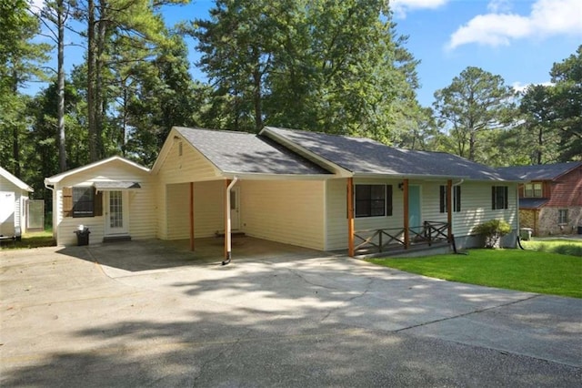 ranch-style home featuring a front yard and a carport