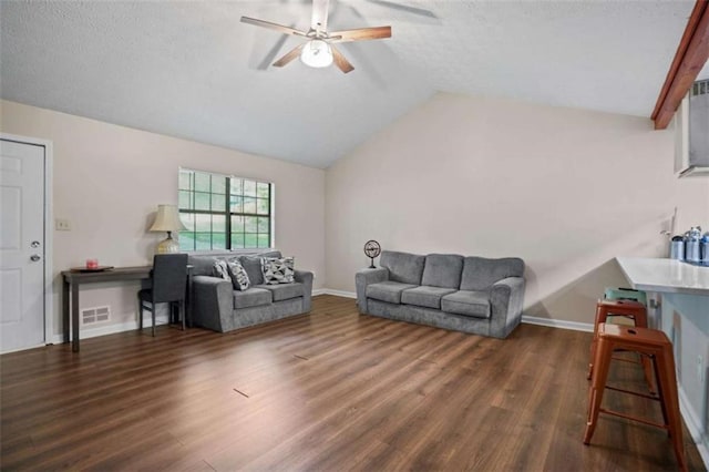 living room with dark wood-type flooring, ceiling fan, vaulted ceiling, and a textured ceiling