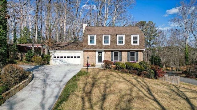 colonial inspired home featuring a garage, brick siding, concrete driveway, a front lawn, and a chimney