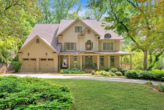 3925 Sheldon Dr NE, Atlanta, GA 30342 - view of front of home featuring a porch, a standing seam roof, a front yard, and driveway
