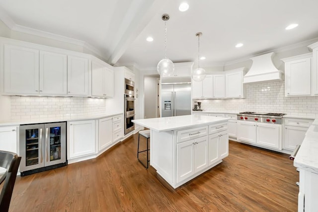 3925 Sheldon Dr NE, Atlanta, GA 30342 - kitchen featuring built in appliances, wine cooler, wall chimney exhaust hood, decorative backsplash, and a center island