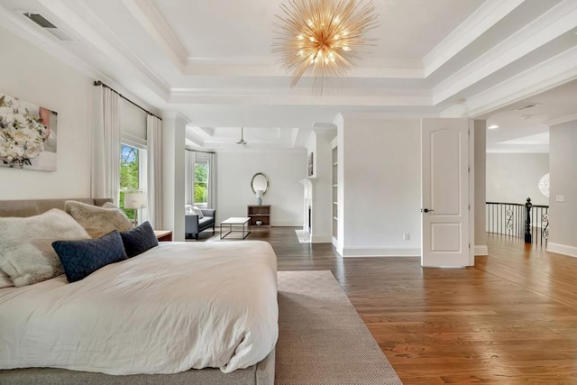 3925 Sheldon Dr NE, Atlanta, GA 30342 - bedroom featuring a tray ceiling, wood finished floors, crown molding, a chandelier, and baseboards