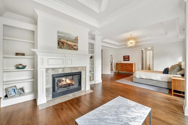 3925 Sheldon Dr NE, Atlanta, GA 30342 - bedroom featuring a tray ceiling, crown molding, a tiled fireplace, and wood finished floors