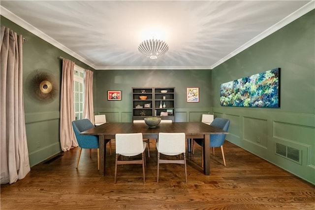 3925 Sheldon Dr NE, Atlanta, GA 30342 - dining space featuring a decorative wall, wood finished floors, crown molding, and wainscoting