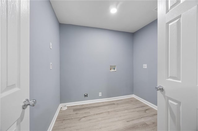 laundry area featuring hookup for a washing machine and light hardwood / wood-style flooring