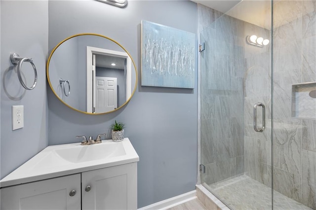 bathroom featuring vanity and a shower with shower door