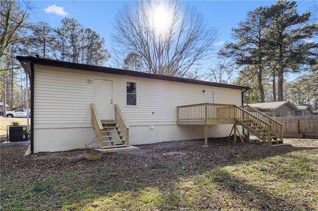 rear view of property with a wooden deck