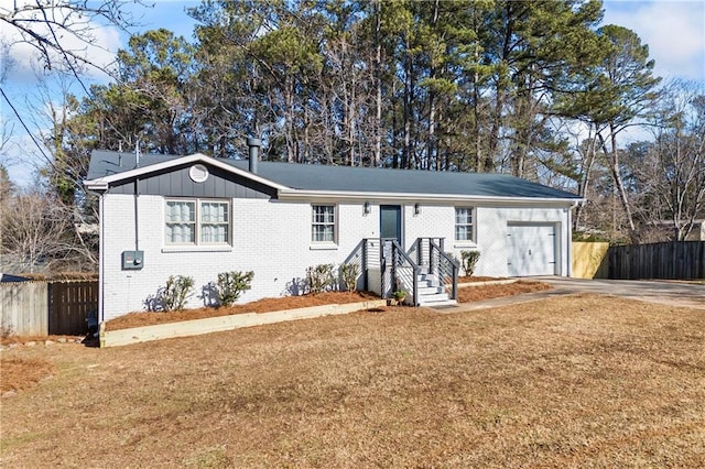 ranch-style home featuring a garage and a front yard