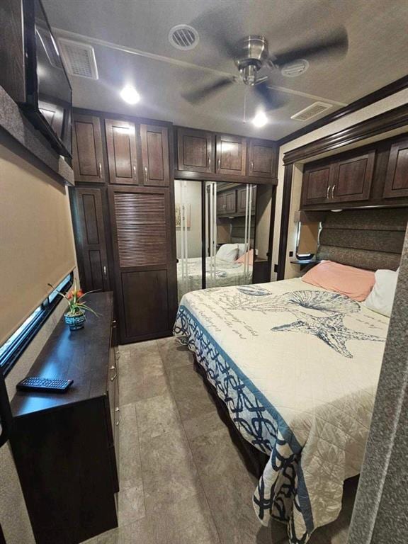 tiled bedroom featuring ceiling fan