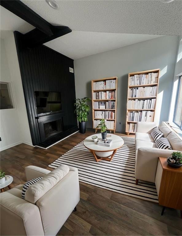 living room featuring dark hardwood / wood-style flooring and a textured ceiling