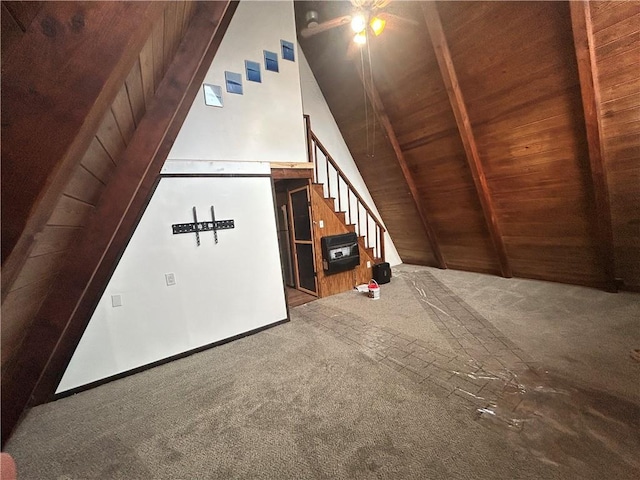 bonus room featuring lofted ceiling with beams, carpet, wooden ceiling, and wooden walls