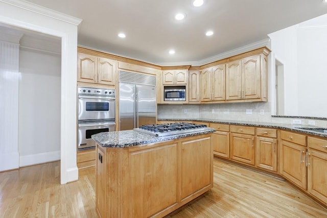 kitchen featuring decorative backsplash, crown molding, built in appliances, stone countertops, and light hardwood / wood-style flooring