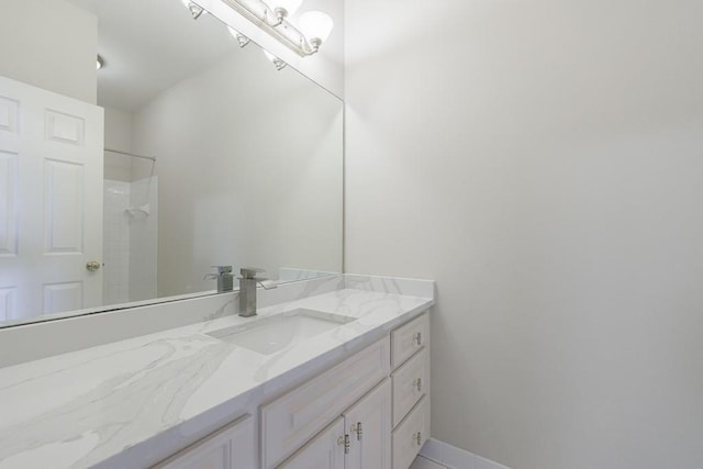 bathroom with vanity and a shower