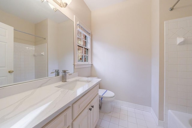 full bathroom featuring tile patterned flooring, vanity, toilet, and tiled shower / bath