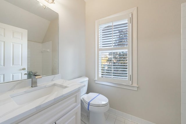 bathroom with vanity, vaulted ceiling, tile patterned flooring, toilet, and walk in shower