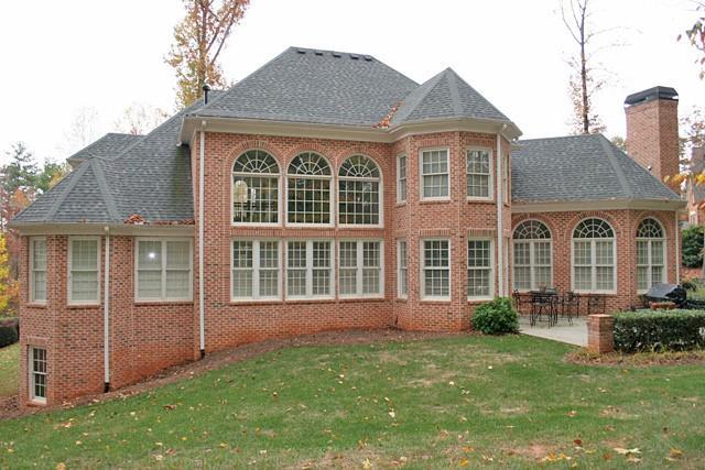 rear view of property with a yard and a patio area