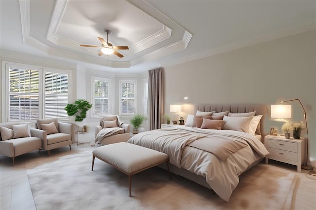 bedroom with a tray ceiling, ceiling fan, and crown molding