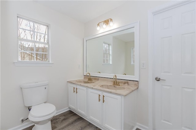 bathroom with hardwood / wood-style flooring, vanity, and toilet