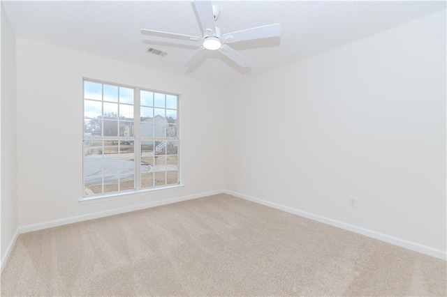 spare room with carpet floors and ceiling fan