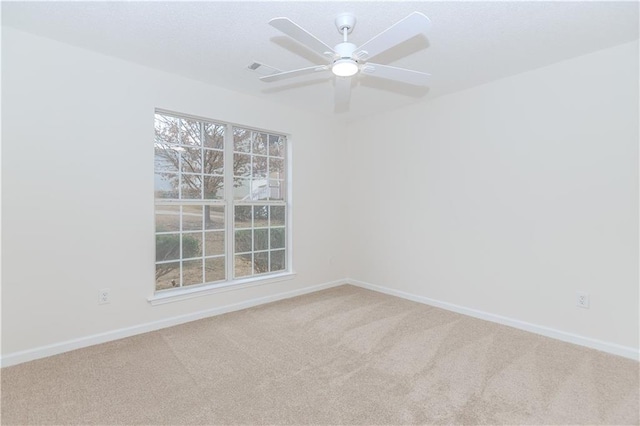 carpeted empty room featuring ceiling fan