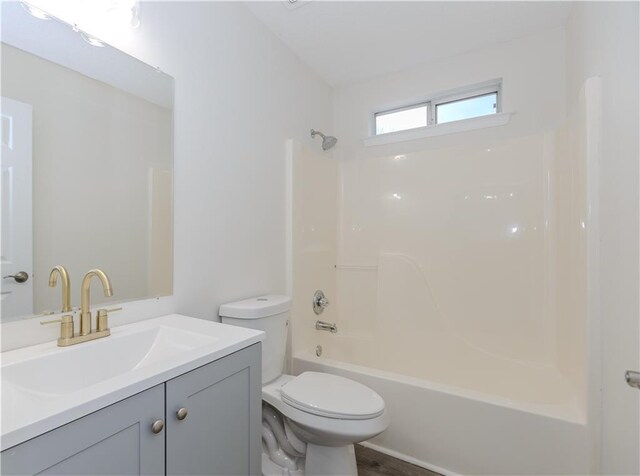 full bathroom with vanity, tub / shower combination, and toilet