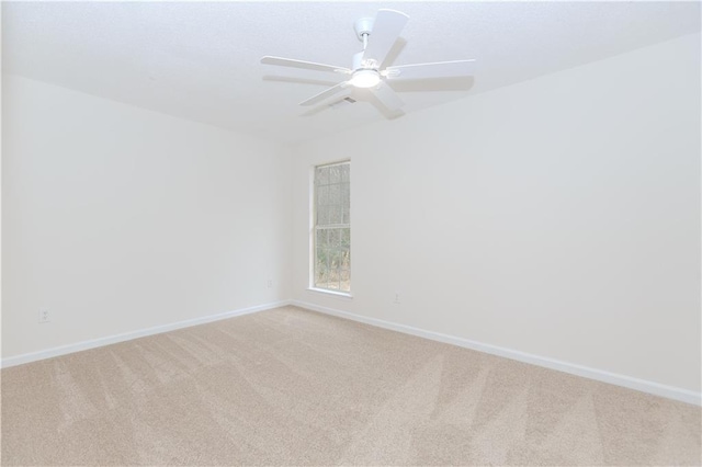 unfurnished room featuring light carpet and ceiling fan