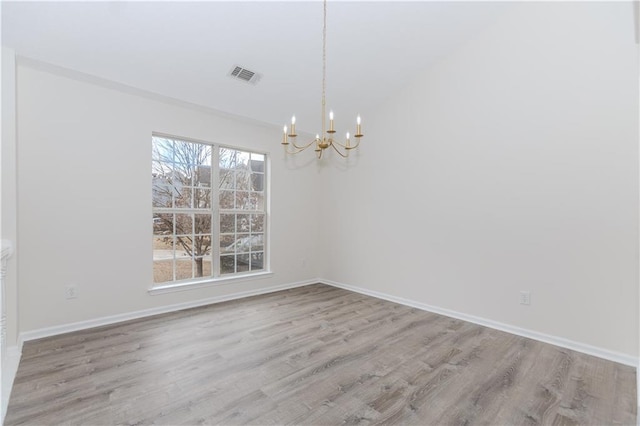 unfurnished dining area with a notable chandelier and light hardwood / wood-style floors