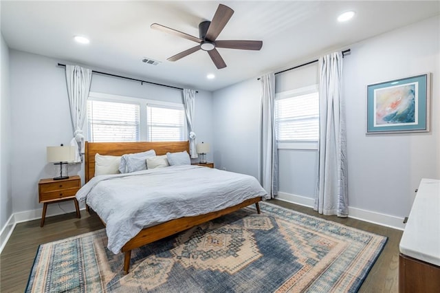 bedroom with a ceiling fan, recessed lighting, dark wood finished floors, and baseboards