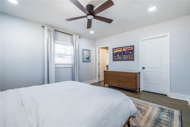 bedroom with baseboards, dark wood finished floors, a ceiling fan, and recessed lighting