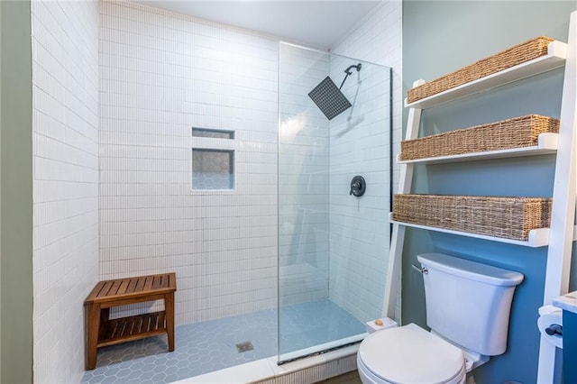 bathroom with tiled shower and toilet