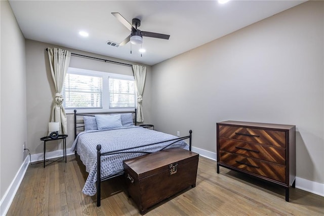 bedroom with recessed lighting, visible vents, a ceiling fan, wood finished floors, and baseboards