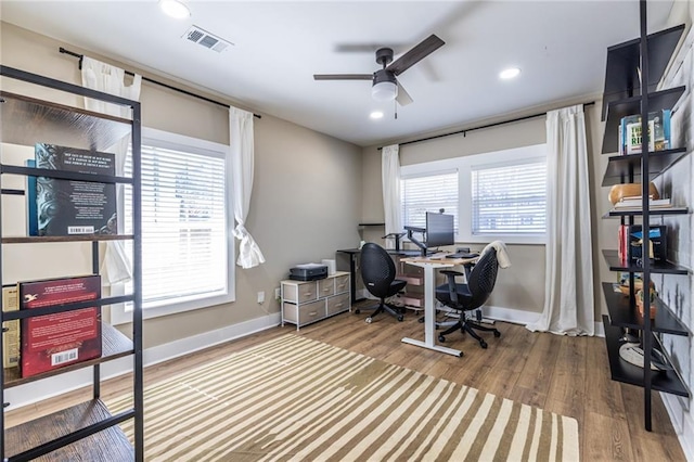 home office featuring baseboards, visible vents, ceiling fan, and wood finished floors