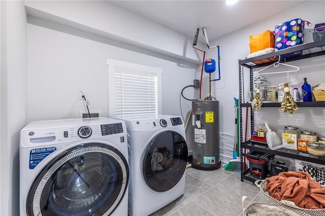 laundry area featuring laundry area, light tile patterned flooring, washing machine and clothes dryer, and electric water heater