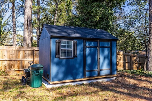 view of shed with a fenced backyard