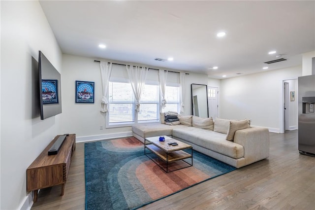 living room featuring recessed lighting, visible vents, and wood finished floors