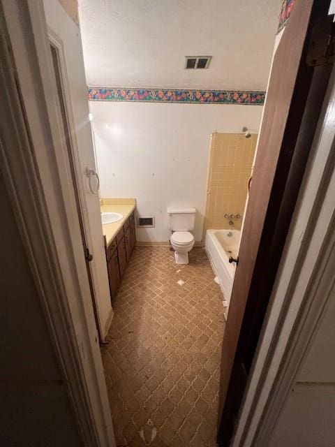 full bathroom with bathtub / shower combination, vanity, and toilet