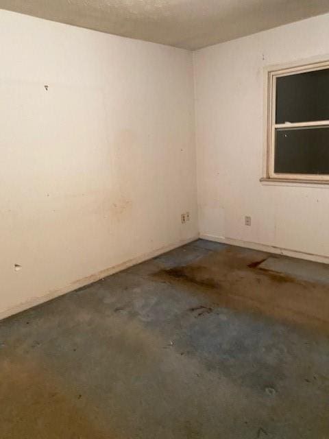 unfurnished room featuring concrete floors