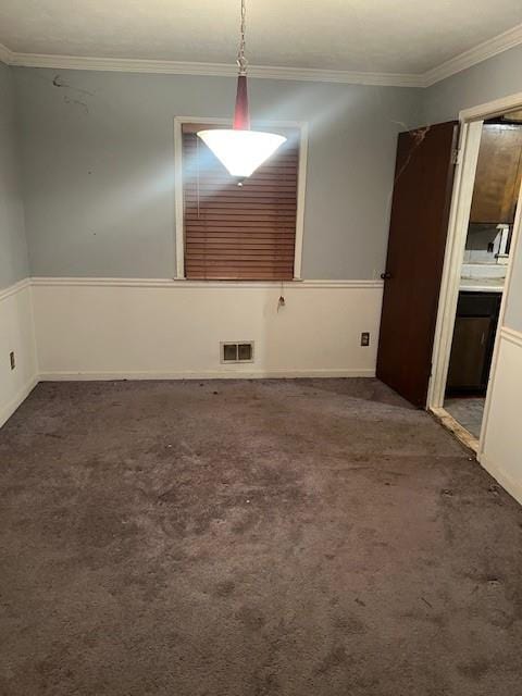 carpeted spare room with crown molding