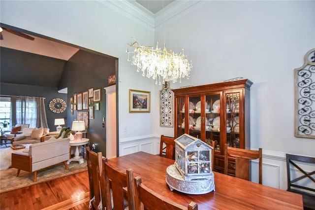 4742 Thunder River Dr, Gainesville, GA 30506 - dining room featuring a decorative wall, a chandelier, wood finished floors, crown molding, and a wainscoted wall