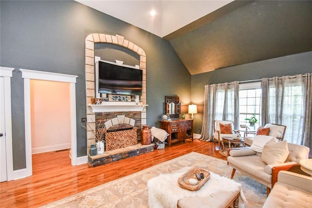 4742 Thunder River Dr, Gainesville, GA 30506 - living area featuring wood finished floors, a stone fireplace, and high vaulted ceiling