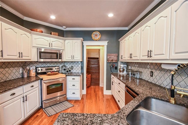 4742 Thunder River Dr, Gainesville, GA 30506 - kitchen with stainless steel appliances, light wood finished floors, backsplash, dark stone counters, and ornamental molding